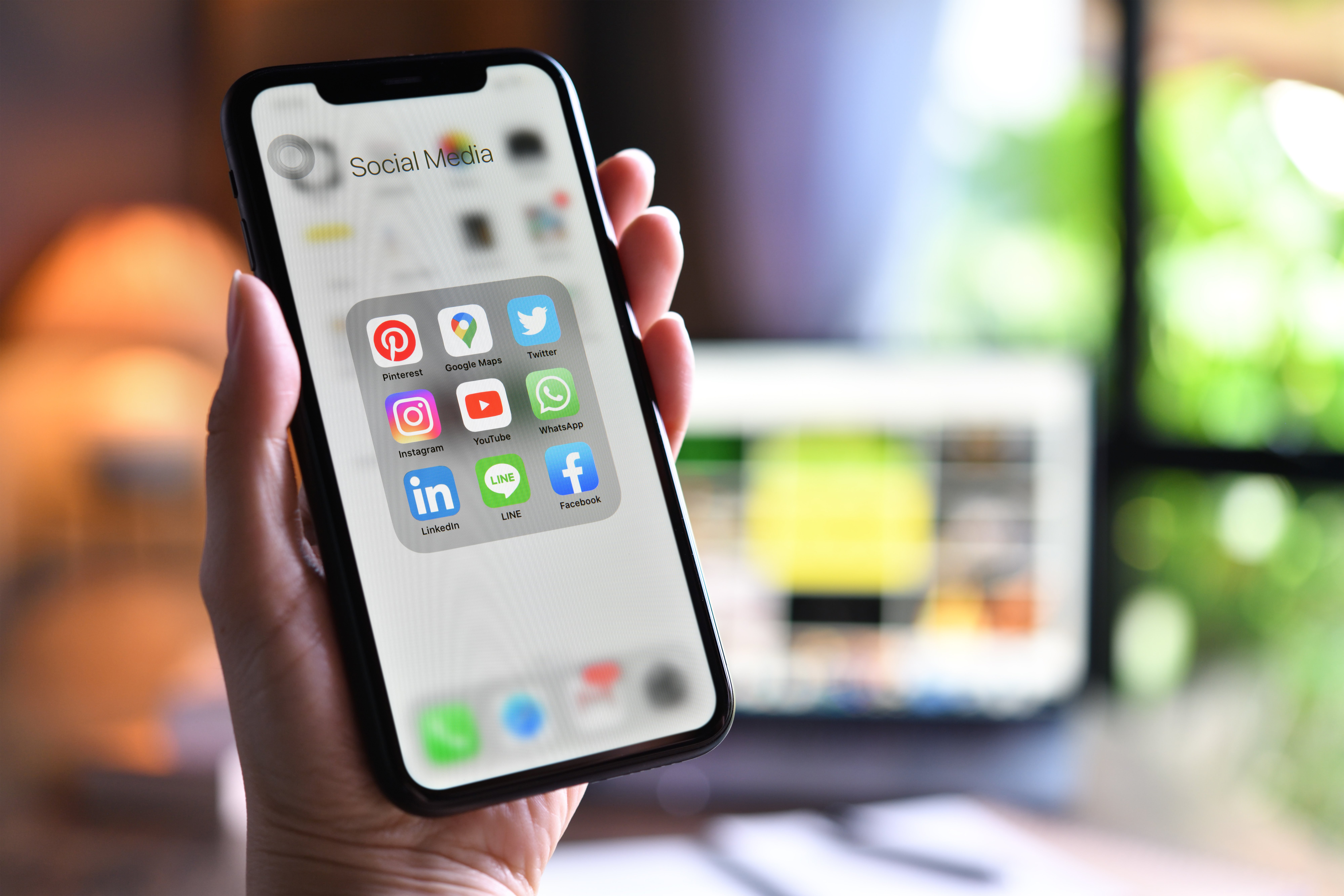 female-holding-smartphone-with-icons-social-media-screen-home female-holding-smartphone-with-icons-social-media-screen-home